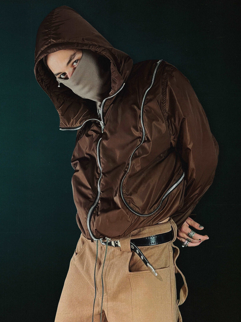 The Water Resistant Brown Nylon Outer jacket from RÊVEUR LUCIDE, made in Paris, France. This jacket features ‘R L’ paneling, oversized ‘L’ pocket, and a zipper pocket on the front right. With a wadding shell of polyester/cotton twill, Raccagni zippers, and an Atelier patch on the back, this jacket is both stylish and functional. The relaxed cropped fit is true to size.
