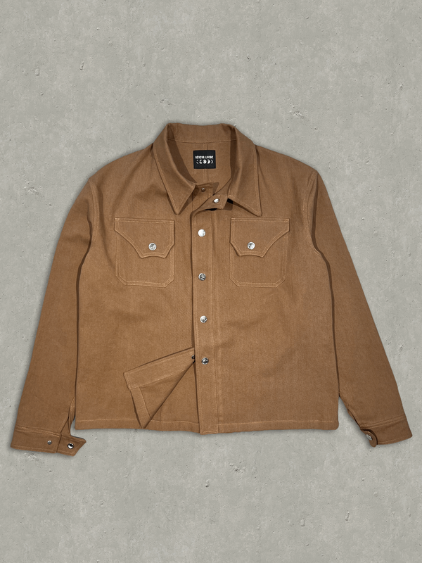 RÊVEUR LUCIDE's Brown Cotton Twill shirt, made in Paris, France. This shirt features patch pockets on the front chest and custom button snap closures on the front and cuffs. With a relaxed cropped fit that's true to size, this shirt is both stylish and comfortable. Shop now and add this versatile piece to your wardrobe today.